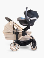 Beige stroller with black car seat on a white background
